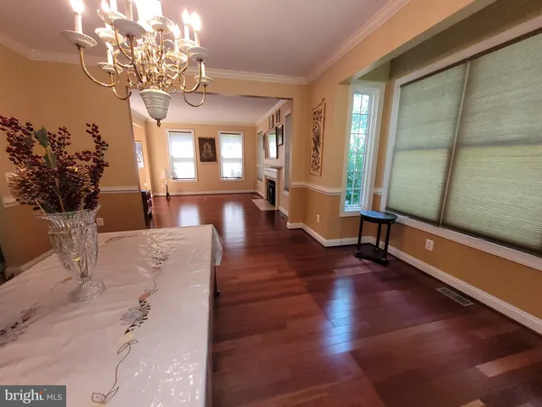 a view of a room with wooden floor and large windows