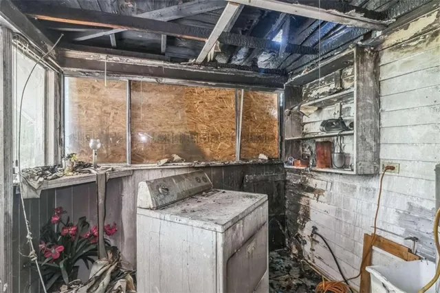 an empty room with windows and closet