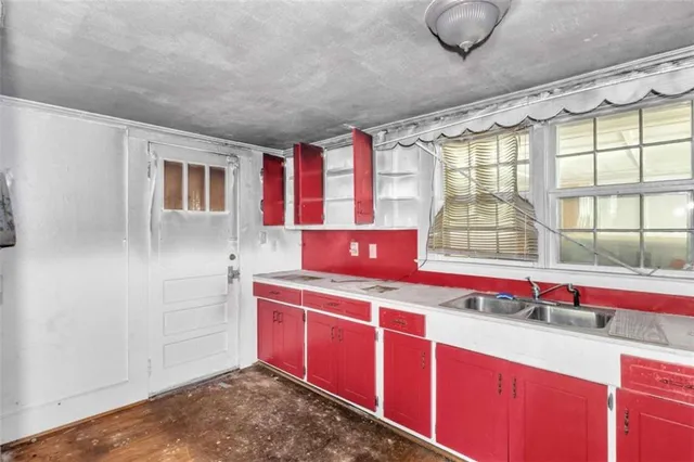 a kitchen with granite countertop a sink and a wooden cabinets