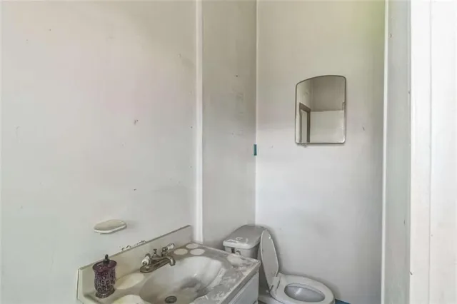 a bathroom with a sink toilet and mirror