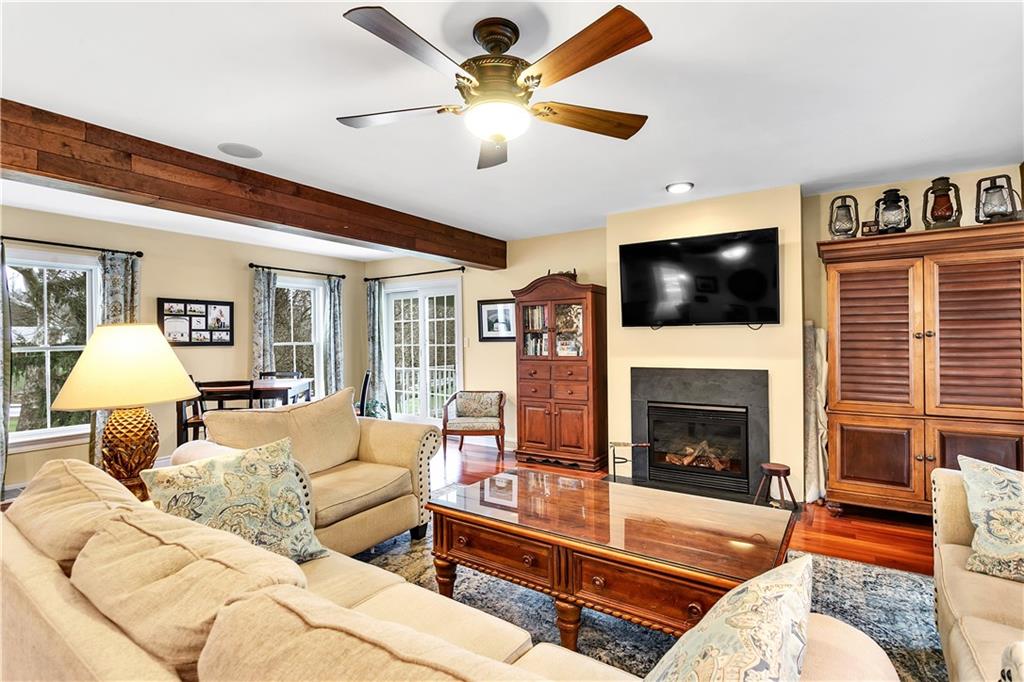 2333 Lesnett Road Pittsburgh, PA 15241 - Photo 5 of 25 a living room with furniture a flat screen tv and a fireplace