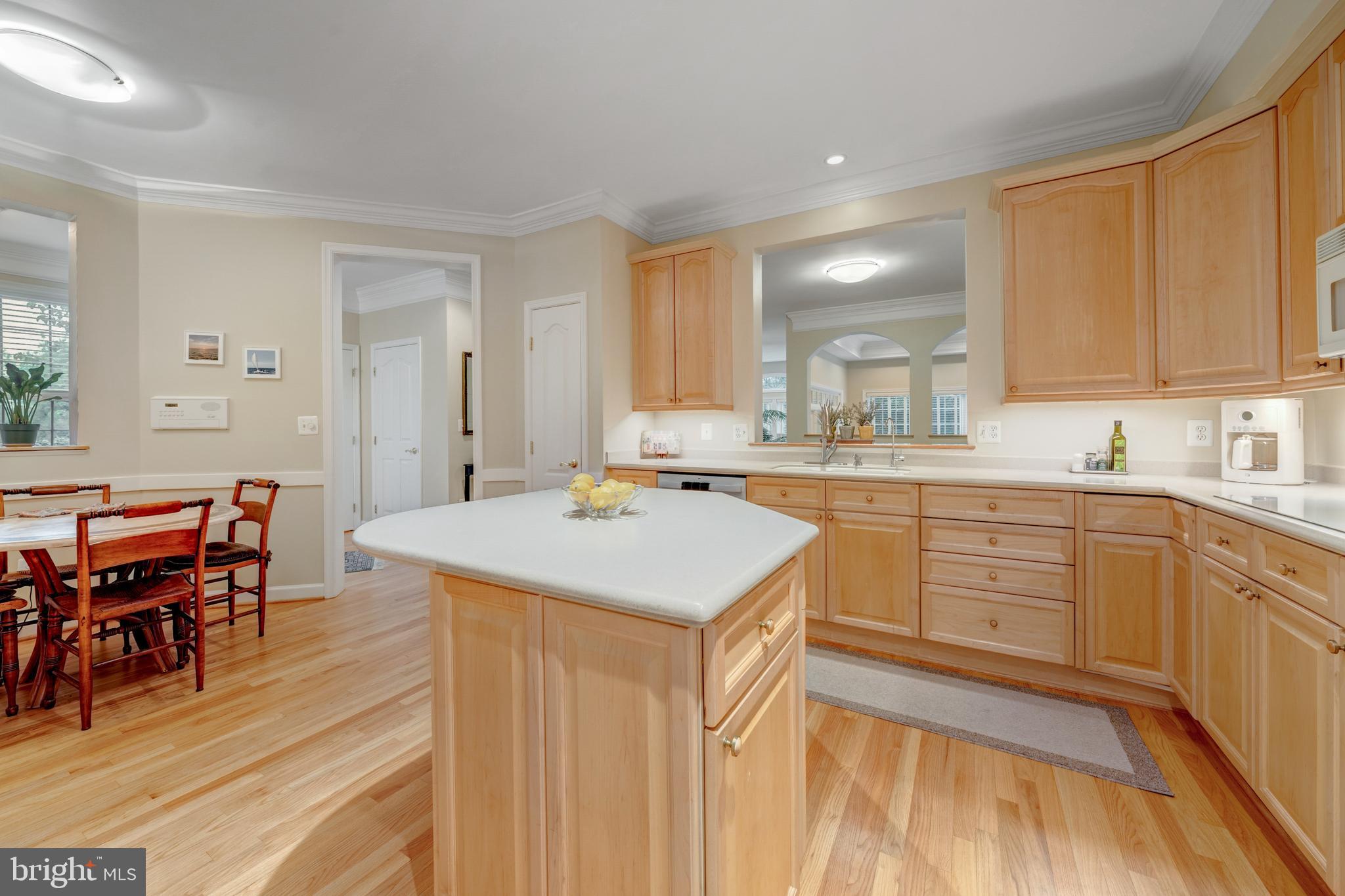 1925 Logan Manor Drive Reston, VA 20190 - Photo 17 of 61 a kitchen with a stove a sink a dining table and chairs