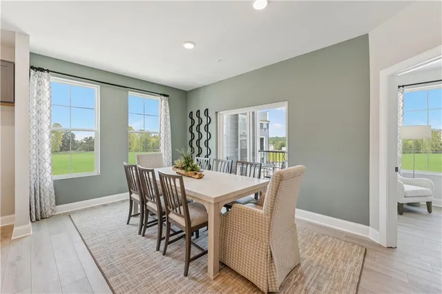 a view of a dining room with furniture window and wooden floor