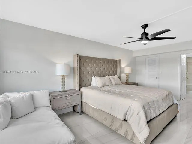 a bedroom with a bed and a ceiling fan