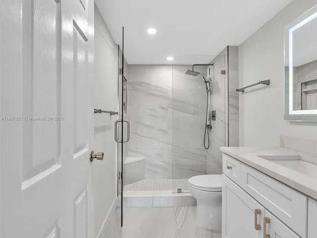 a bathroom with a shower a toilet and sink