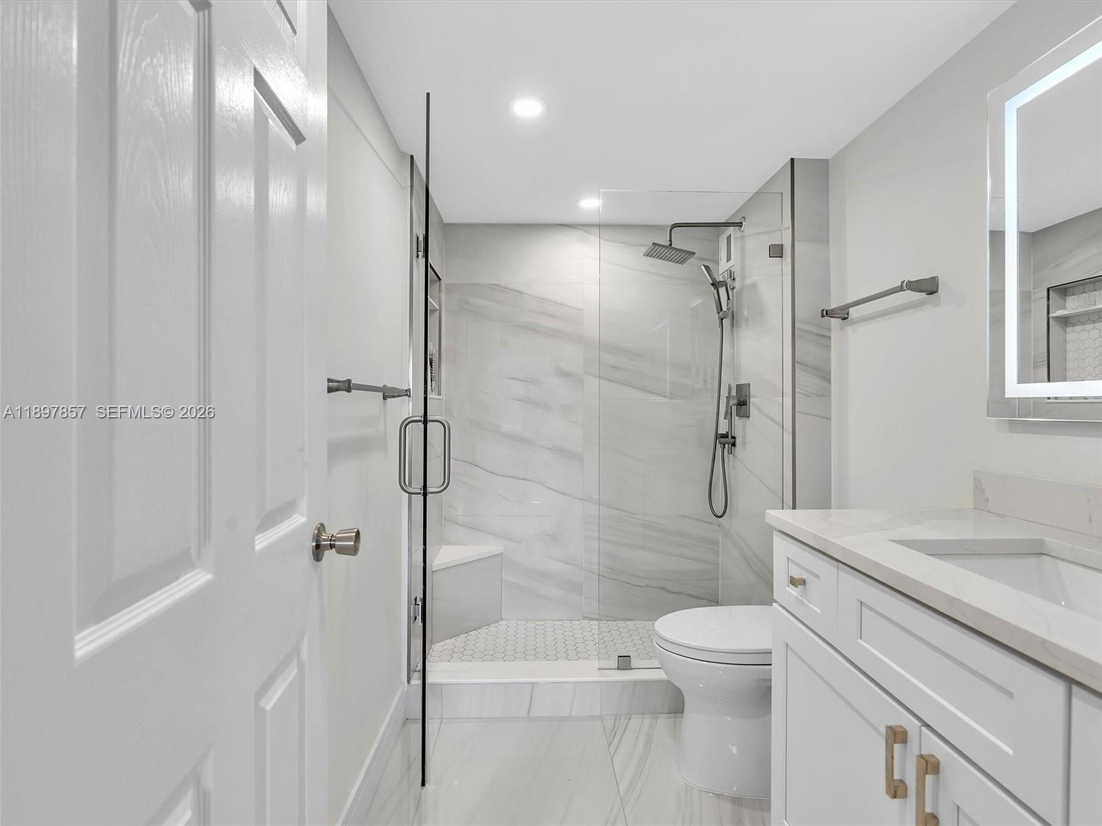 111 North Pompano Beach Boulevard, Unit 308 Pompano Beach, FL 33062 - Photo 15 of 50 a bathroom with a shower a toilet and sink
