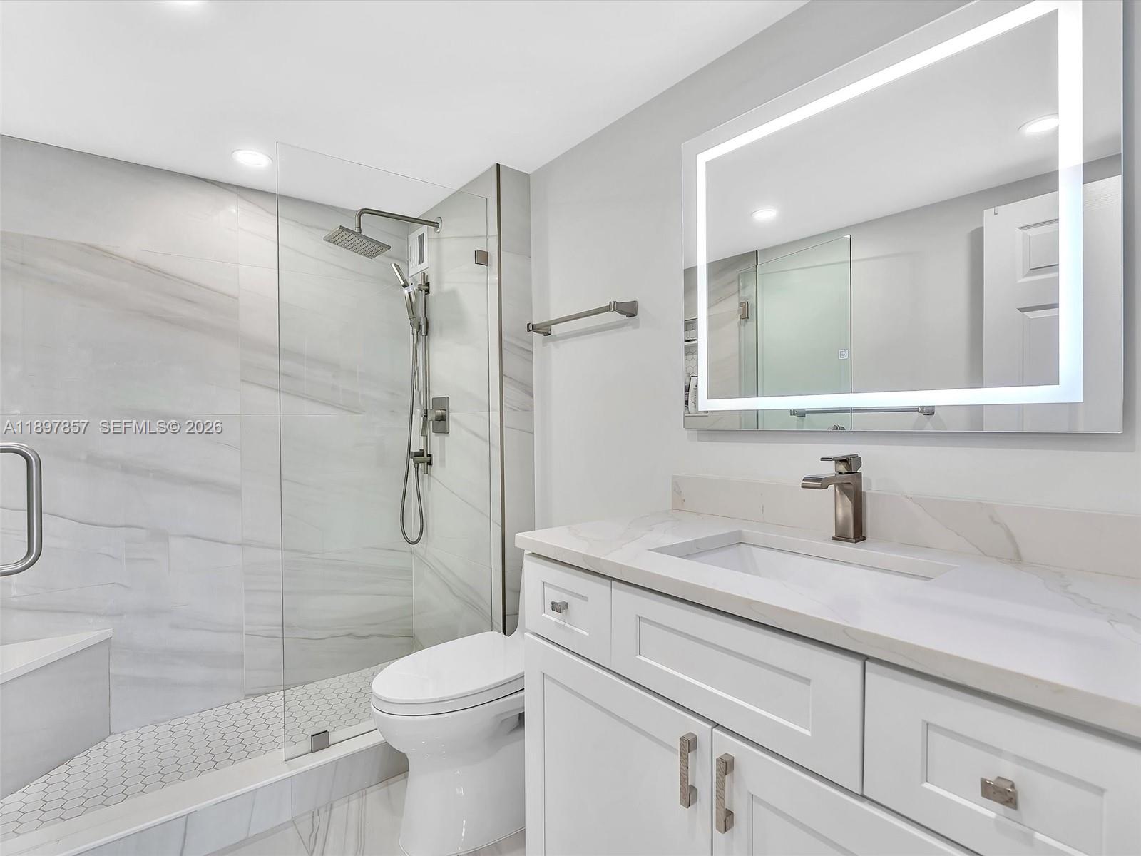 111 North Pompano Beach Boulevard, Unit 308 Pompano Beach, FL 33062 - Photo 16 of 50 a bathroom with a granite countertop sink toilet and shower