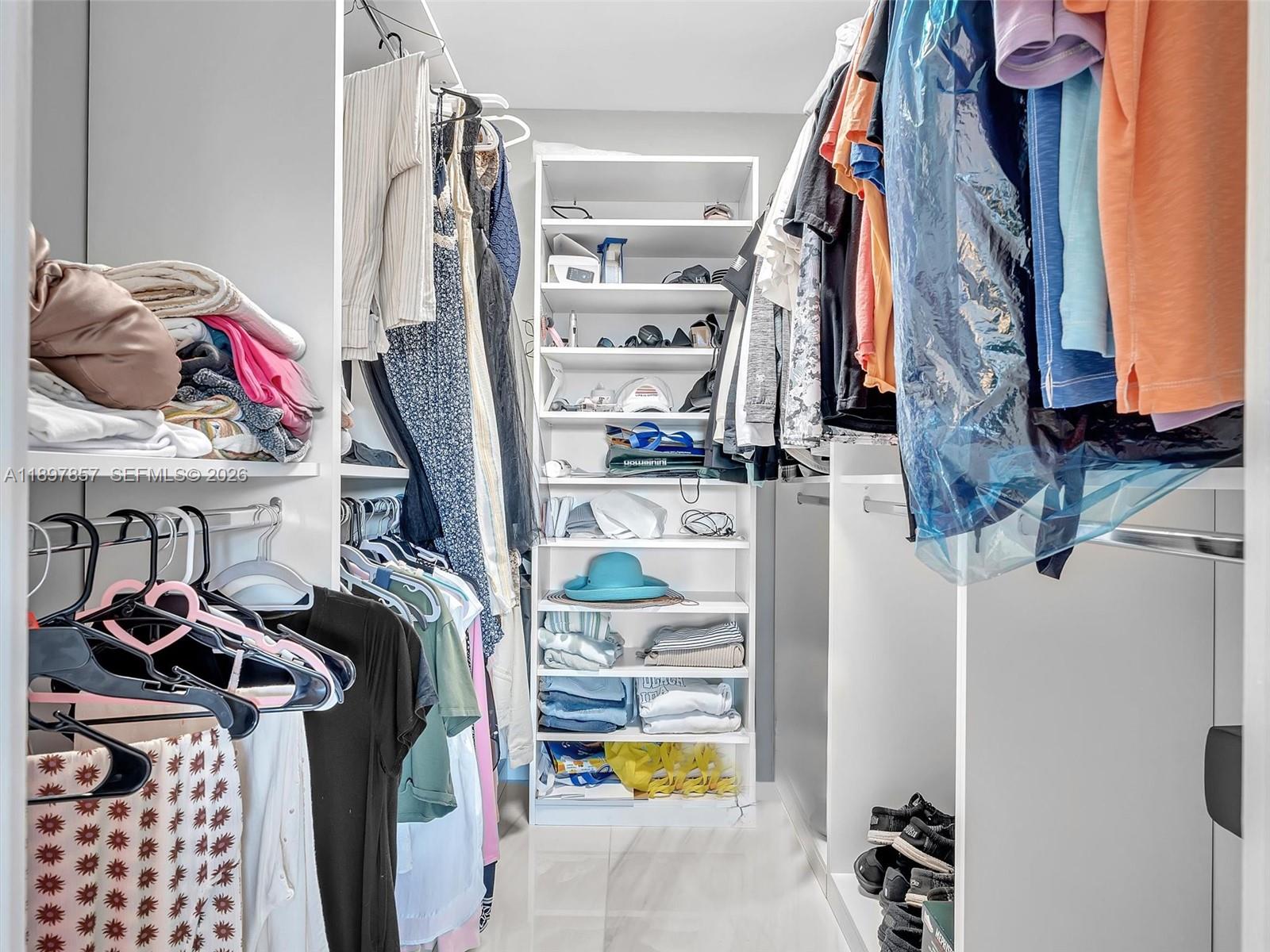 111 North Pompano Beach Boulevard, Unit 308 Pompano Beach, FL 33062 - Photo 17 of 50 a view of walk in closet with clothes and shoes