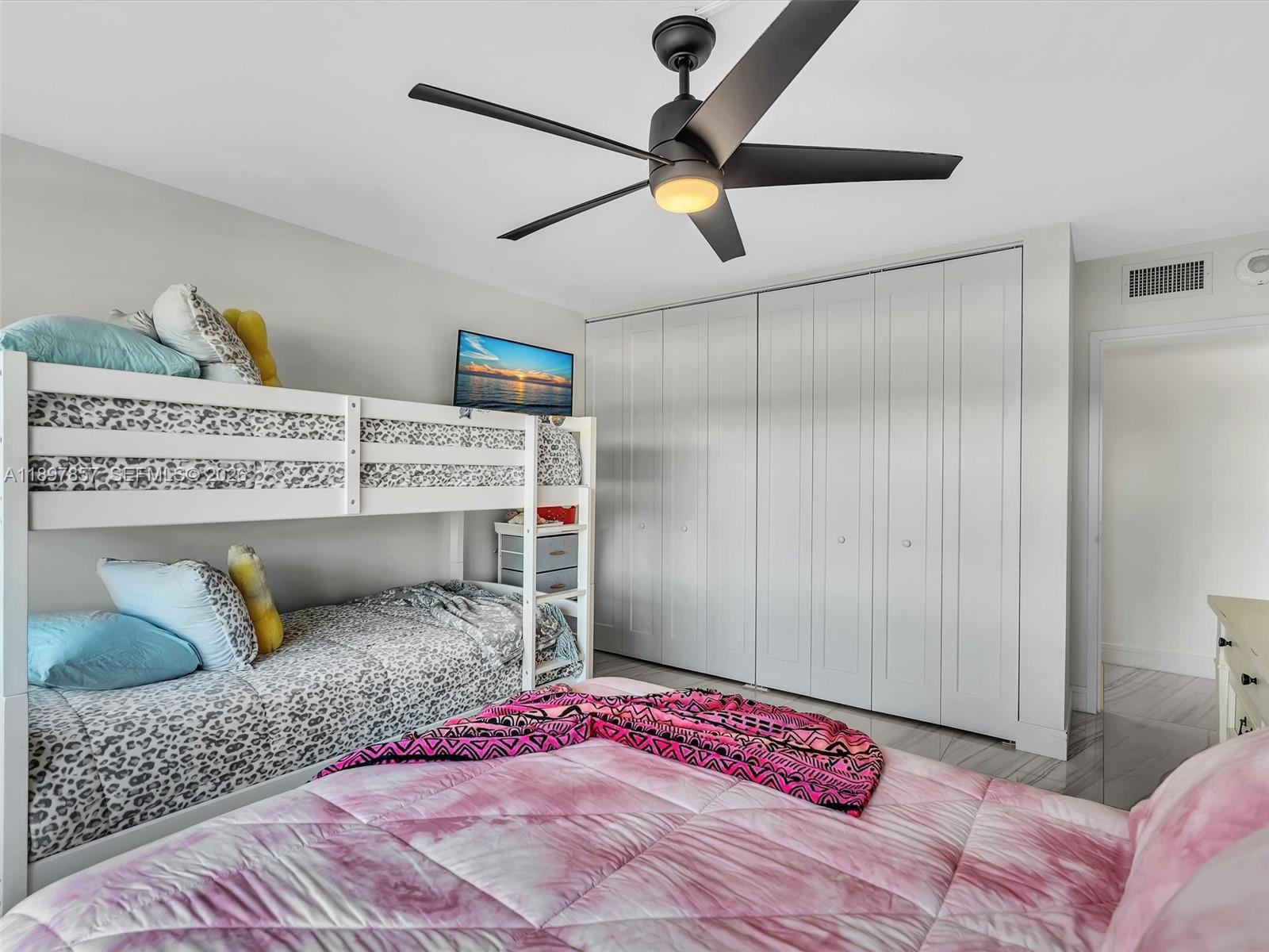 111 North Pompano Beach Boulevard, Unit 308 Pompano Beach, FL 33062 - Photo 19 of 50 a bedroom with a bed and a chandelier