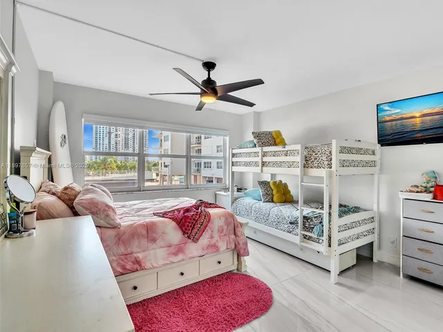 a bedroom with furniture and a large window