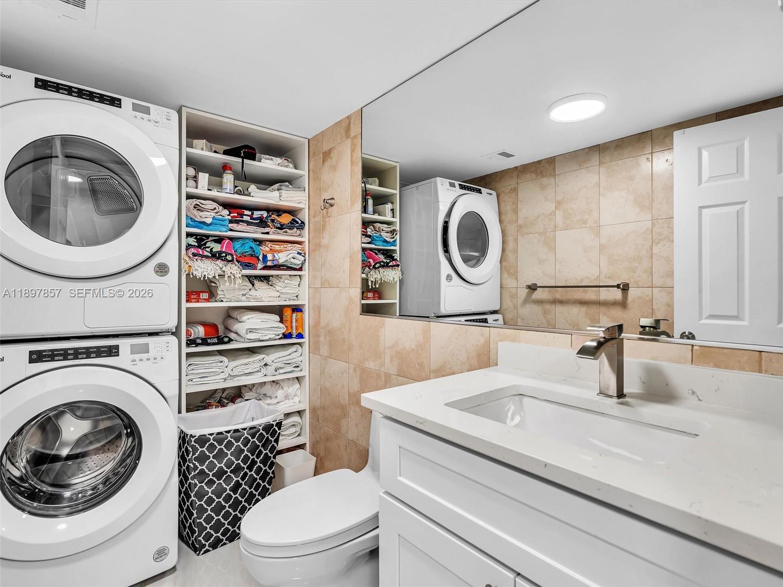 111 North Pompano Beach Boulevard, Unit 308 Pompano Beach, FL 33062 - Photo 25 of 50 a bathroom with a toilet a sink and a mirror