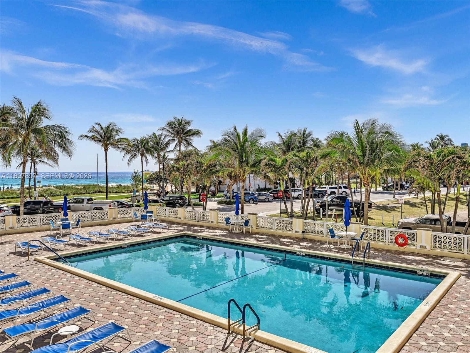 111 North Pompano Beach Boulevard, Unit 308 Pompano Beach, FL 33062 - Photo 33 of 50 a view of a swimming pool with a lawn chairs and swimming pool