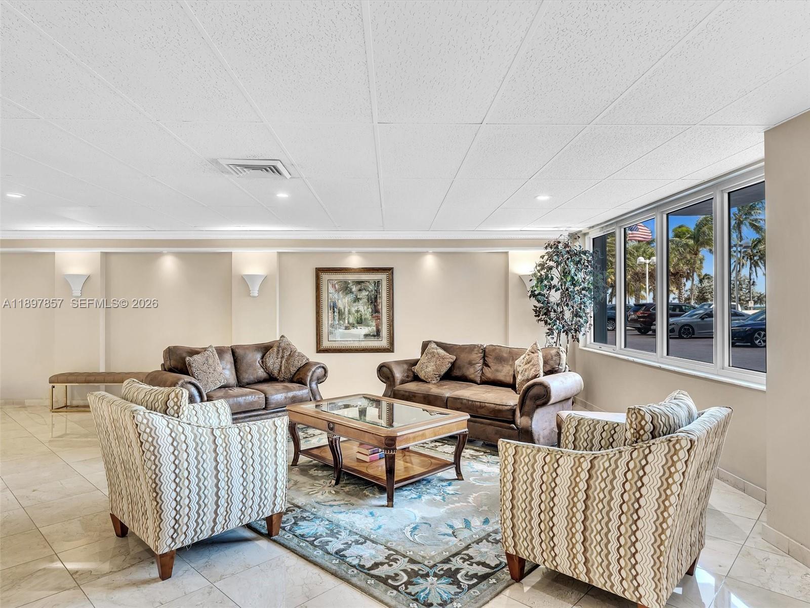 111 North Pompano Beach Boulevard, Unit 308 Pompano Beach, FL 33062 - Photo 35 of 50 a living room with furniture and a large window