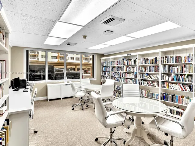 a living room with furniture a large window and table