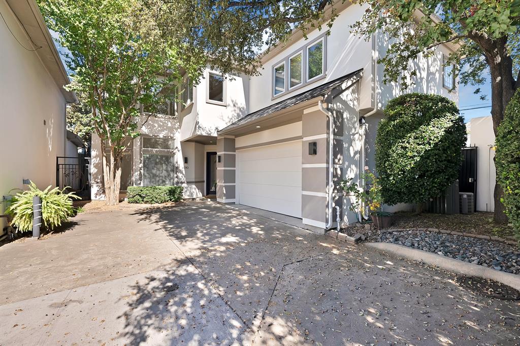 4010 Rawlins Street Dallas, TX 75219 - Photo 2 of 40 View of front of house featuring stucco siding, a garage, and concrete driveway