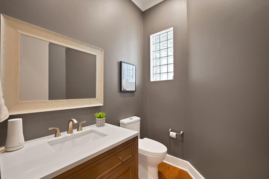 4010 Rawlins Street Dallas, TX 75219 - Photo 21 of 40 Bathroom with vanity, a textured wall, and light wood-style floors