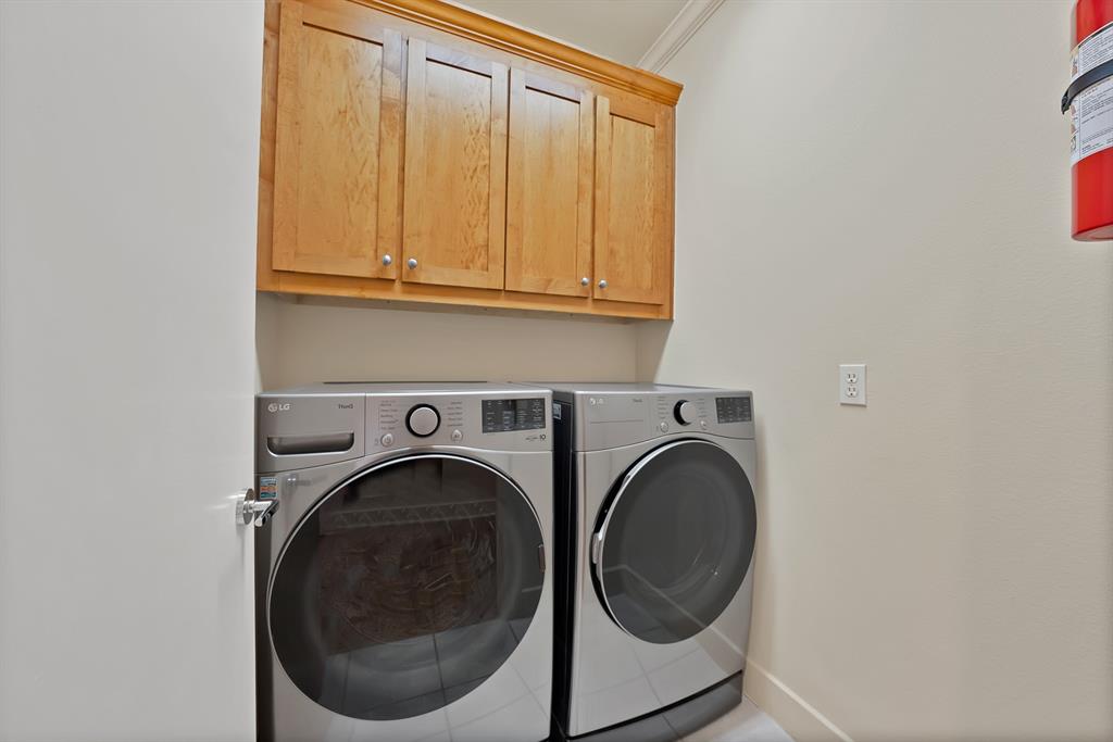 4010 Rawlins Street Dallas, TX 75219 - Photo 23 of 40 Laundry area featuring separate washer and dryer, cabinet space, and crown molding