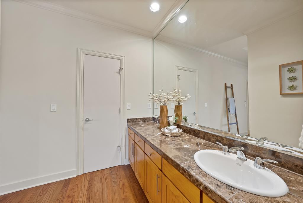 4010 Rawlins Street Dallas, TX 75219 - Photo 27 of 40 Bathroom with light wood-type flooring, double vanity, crown molding, and recessed lighting