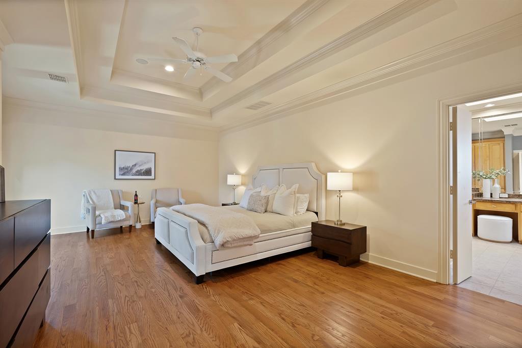 4010 Rawlins Street Dallas, TX 75219 - Photo 29 of 40 Bedroom with crown molding, a ceiling fan, light wood-type flooring, and a tray ceiling