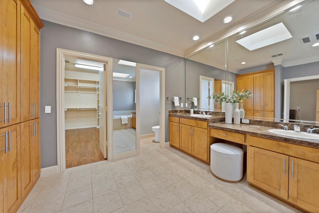 4010 Rawlins Street Dallas, TX 75219 - Photo 34 of 40 Full bath with vanity, a walk in closet, a skylight, crown molding, and recessed lighting