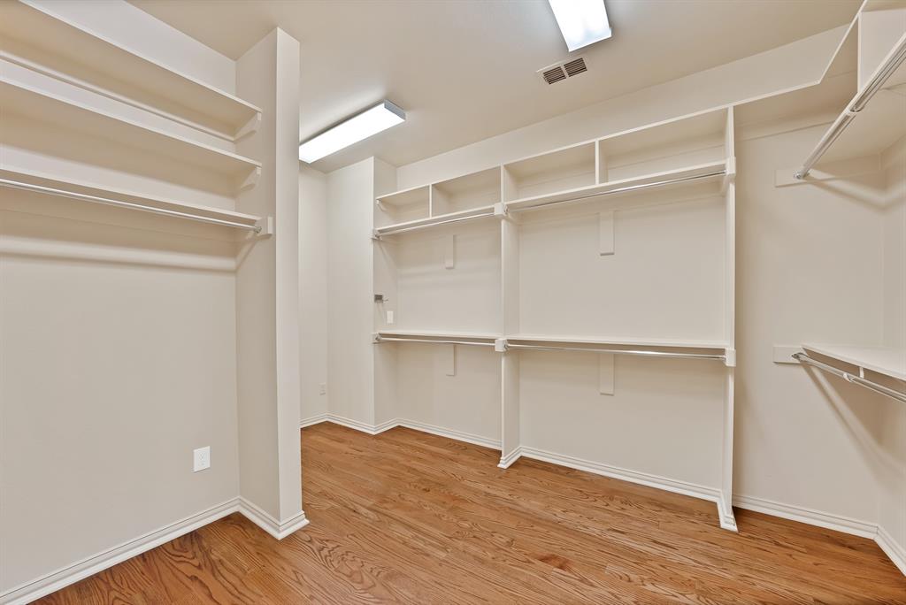 4010 Rawlins Street Dallas, TX 75219 - Photo 37 of 40 Walk in closet with light wood-style floors