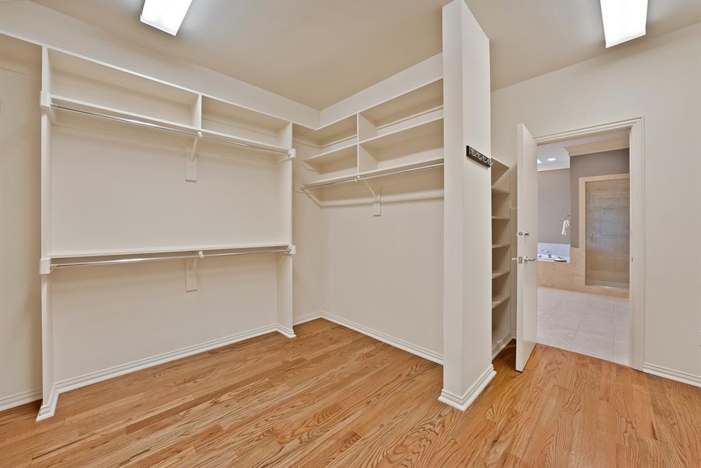 4010 Rawlins Street Dallas, TX 75219 - Photo 38 of 40 Walk in closet with light wood-style flooring