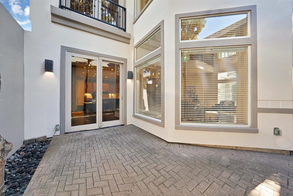 4010 Rawlins Street Dallas, TX 75219 - Photo 40 of 40 Entrance to property featuring stucco siding and a patio area