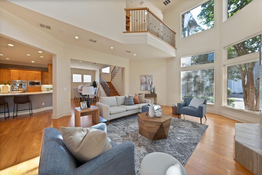 4010 Rawlins Street Dallas, TX 75219 - Photo 6 of 40 Living area with light wood-style floors, ornamental molding, and a high ceiling