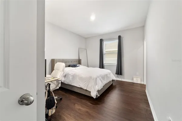 a bedroom with a bed and window