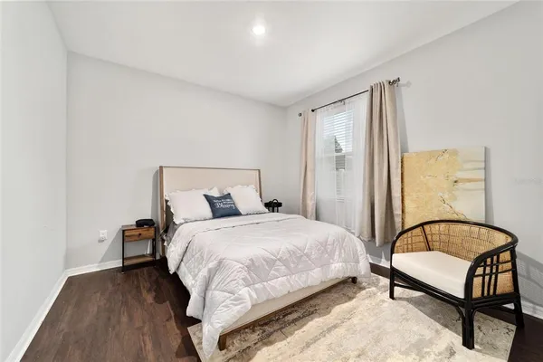 a bedroom with a bed and a couch