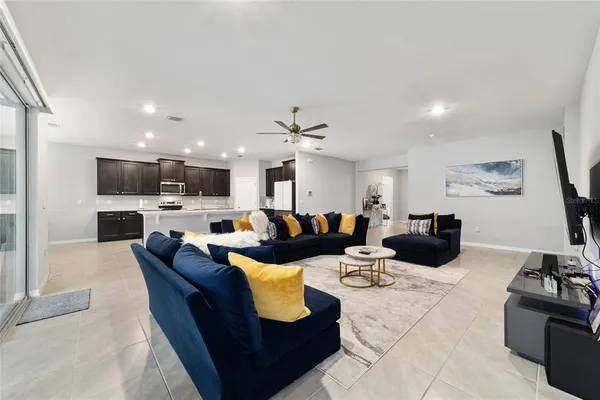 a living room with furniture kitchen and a fireplace