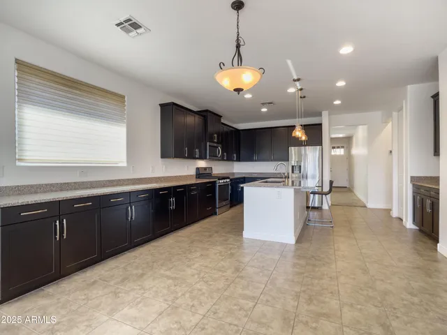 a kitchen with a refrigerator a sink and a cabinets