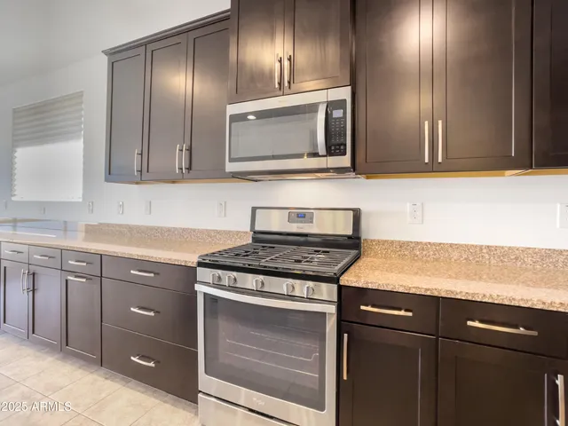 a kitchen with a refrigerator and cabinets