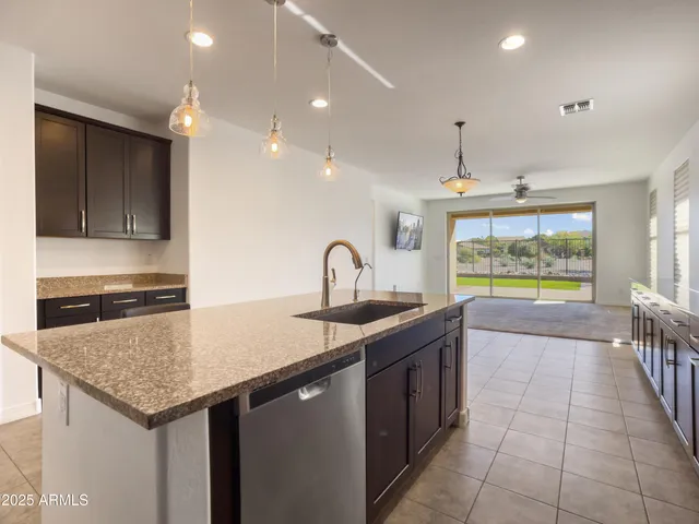 a kitchen with granite countertop stainless steel appliances and cabinets