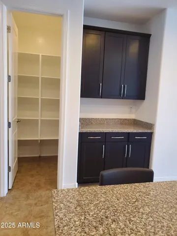 a view of kitchen and a chandelier fan