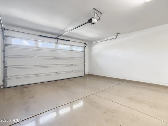 a view of an empty room with a ceiling fan