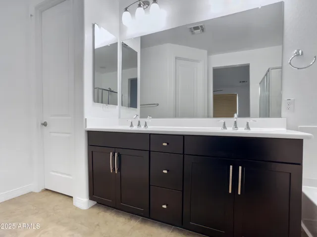 a white toilet sitting next to a white wall