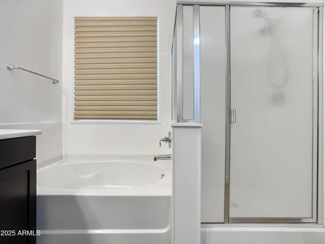 a bedroom with furniture and large window