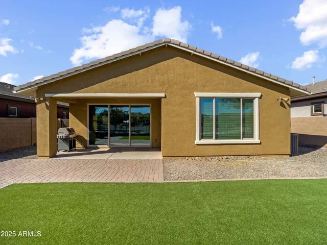 a view of a dry yard with wooden fence