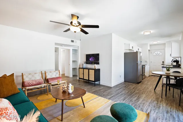 a living room with furniture and a wooden floor