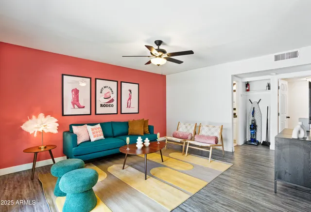 a living room with furniture and wooden floor