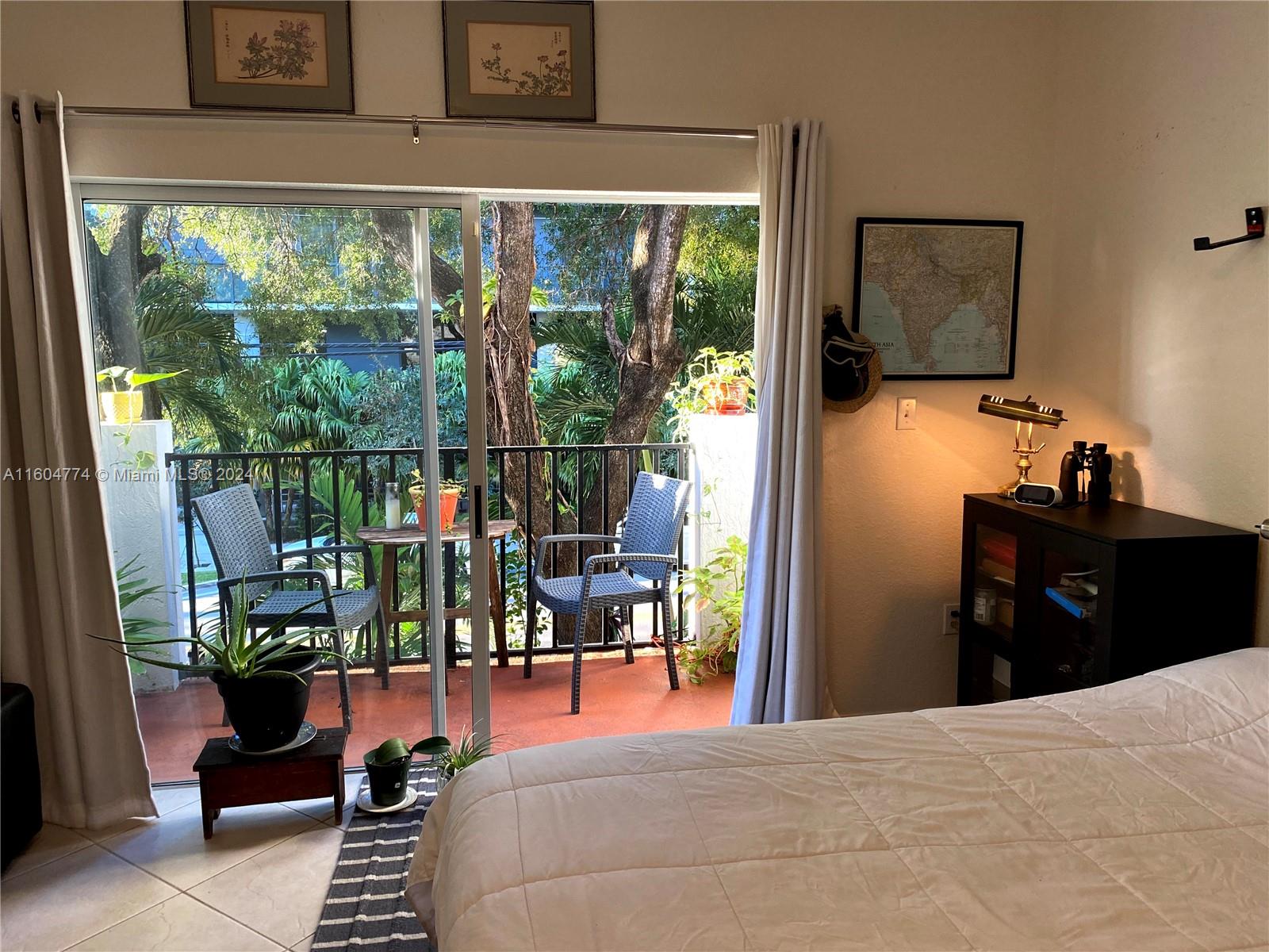 123 Southwest 17th Road, Unit 103 Miami, FL 33129 - Photo 20 of 21 a bedroom with a bed and a window