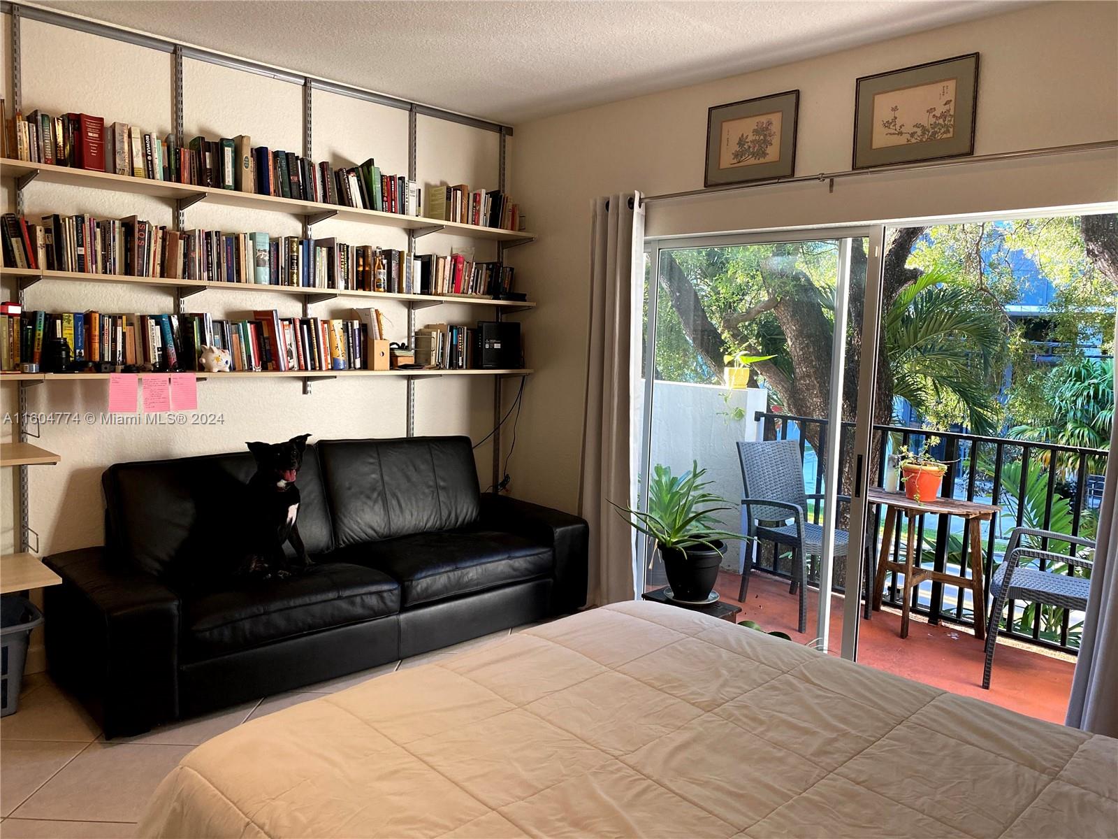 123 Southwest 17th Road, Unit 103 Miami, FL 33129 - Photo 21 of 21 a living room with furniture a window and book shelf