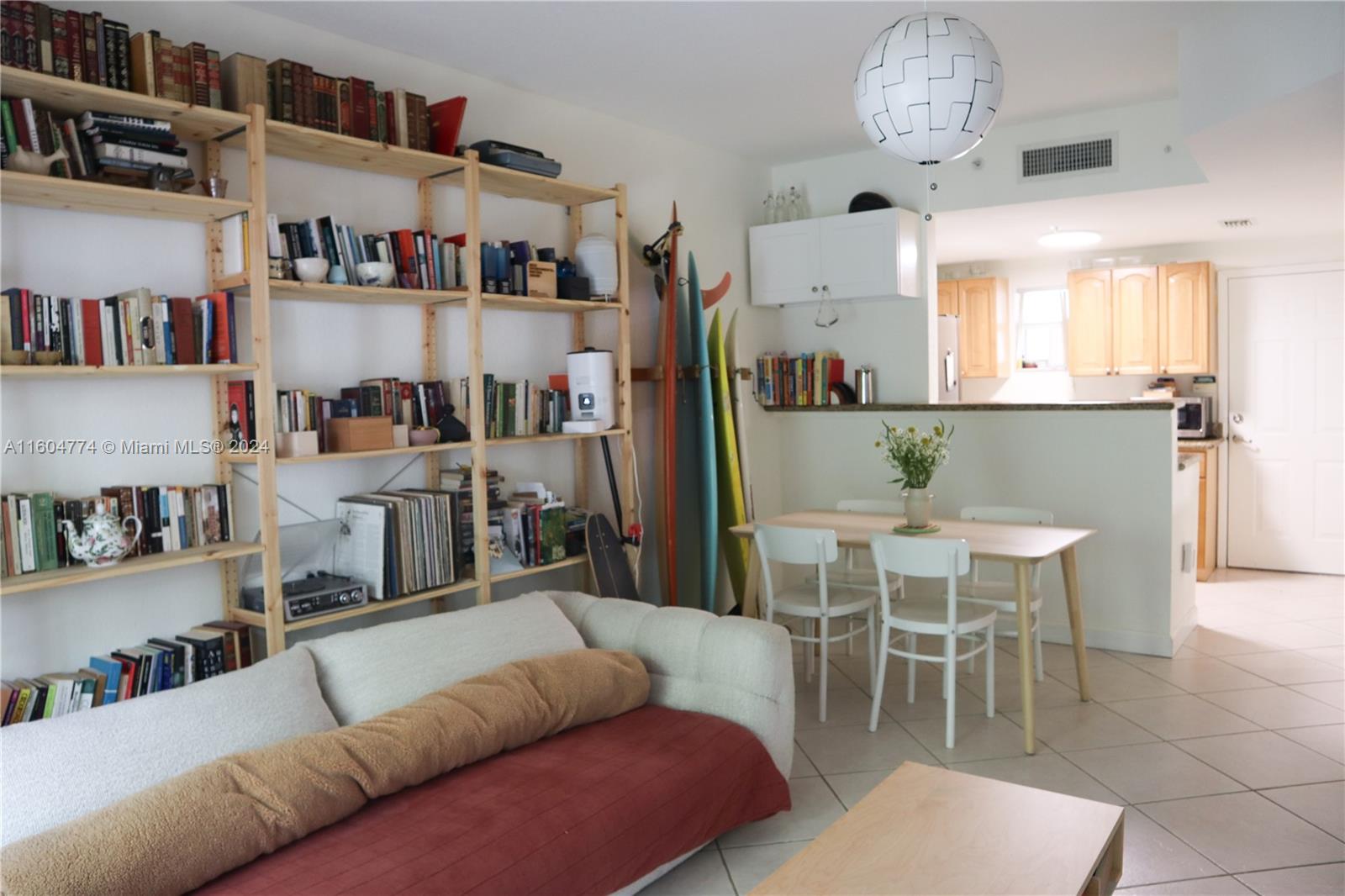 123 Southwest 17th Road, Unit 103 Miami, FL 33129 - Photo 3 of 21 a living room with furniture and a kitchen view