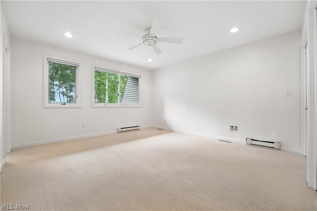 263 East Pine Lake Road North Lima, OH 44452 - Photo 39 of 50 Spare room with a ceiling fan, recessed lighting, light colored carpet, a baseboard heating unit, and baseboard heating