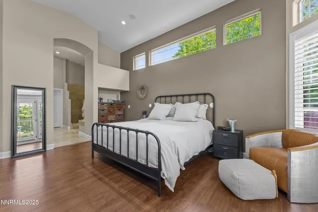 a spacious bedroom with a bed and a walk in closet