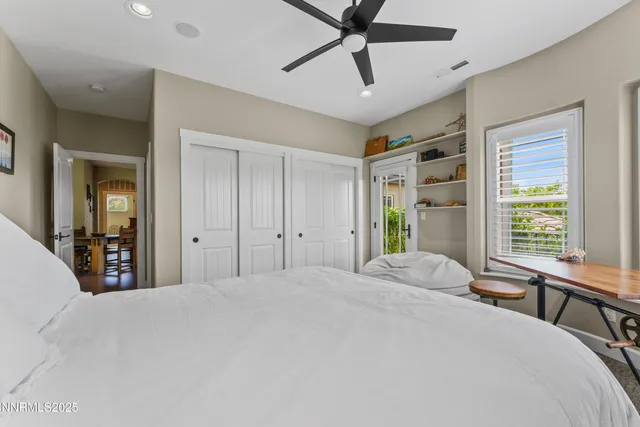 a view of a porch with a floor to ceiling window and wooden fence