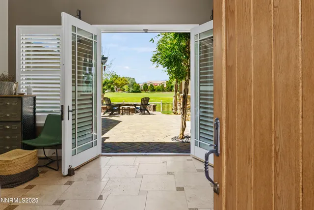 a living room with fireplace furniture and a large window