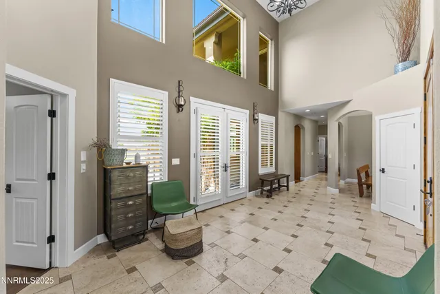 a kitchen with stainless steel appliances granite countertop a sink refrigerator and cabinets