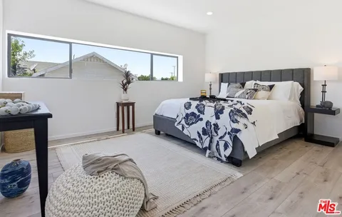a bedroom with a bed and a night stand